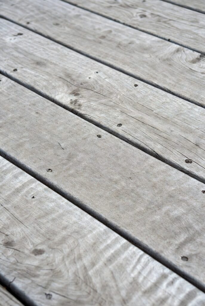 Close-up of weathered Ipe hardwood deck showing silver-grey patina and oxidation from UV exposure and Canadian climate